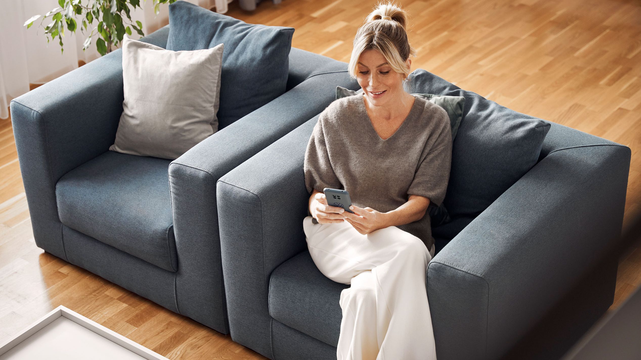 Eine Frau schaut auf ihrem Smartphone nach den neuesten Updates für die ID.-Software